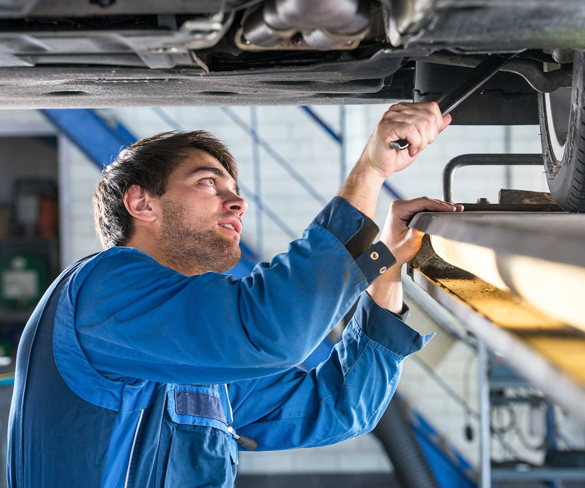 Mechanic working under car